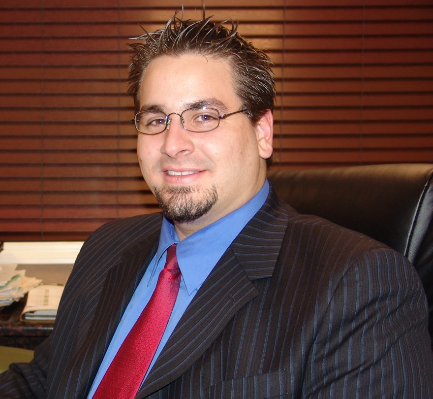 Igor Gomes at his desk in the Somerville office